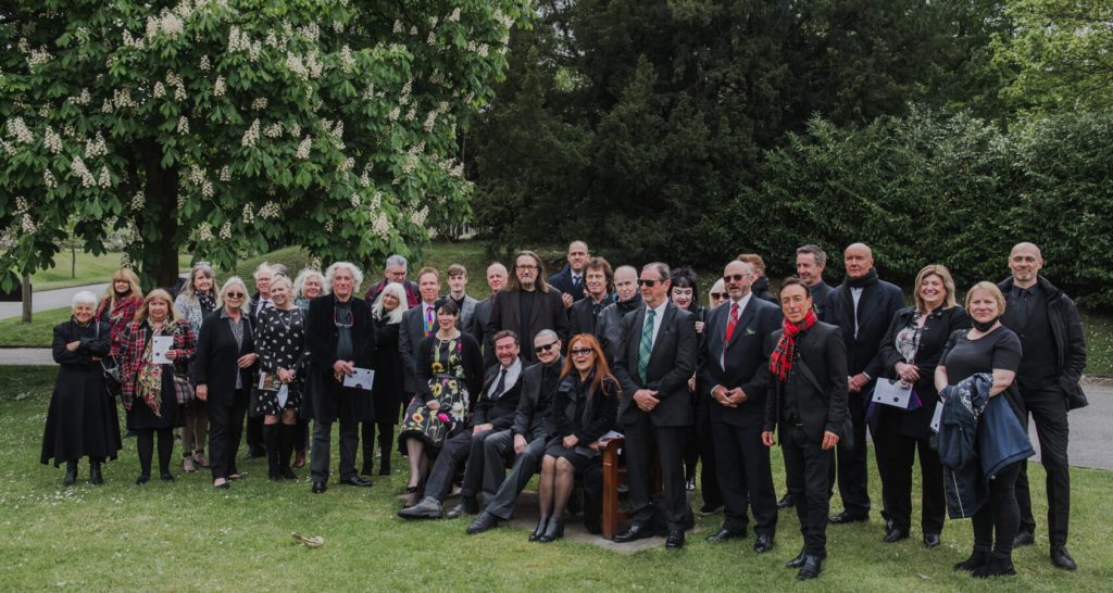 Family and friends gathered outdoors after a personalised funeral ceremony