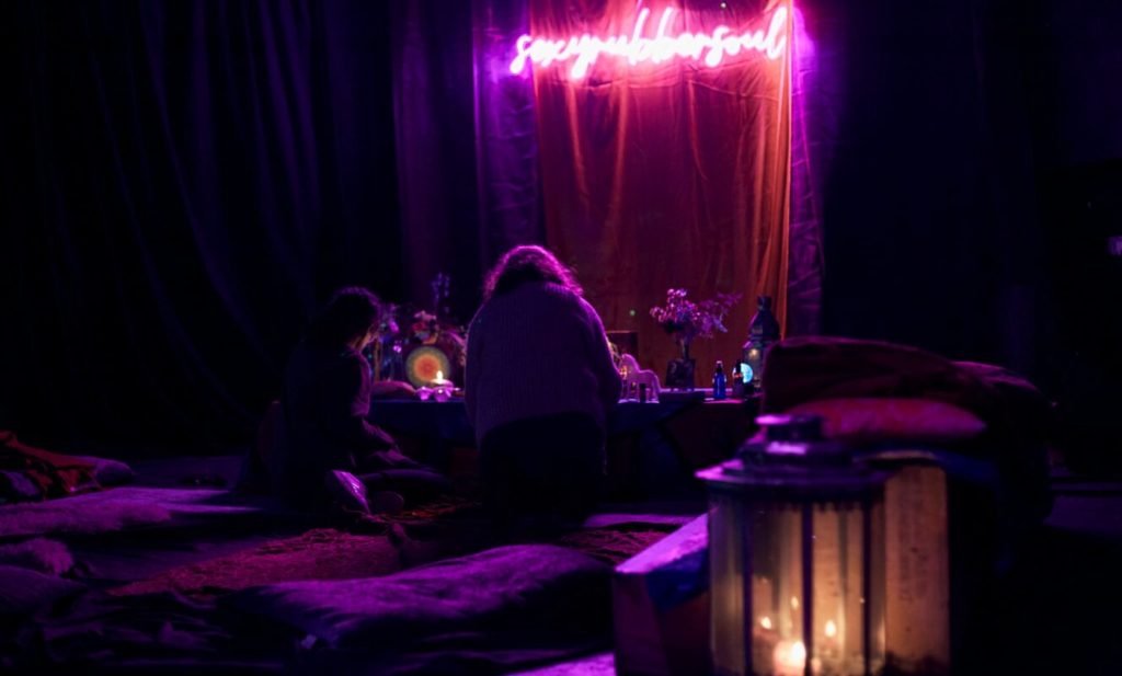 Low-lit area with cushions and candles at a memorial gathering