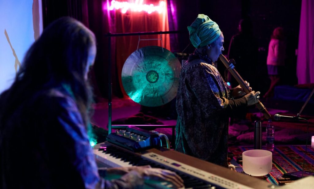 Live musicians performing during a memorial ceremony in an intimate indoor space