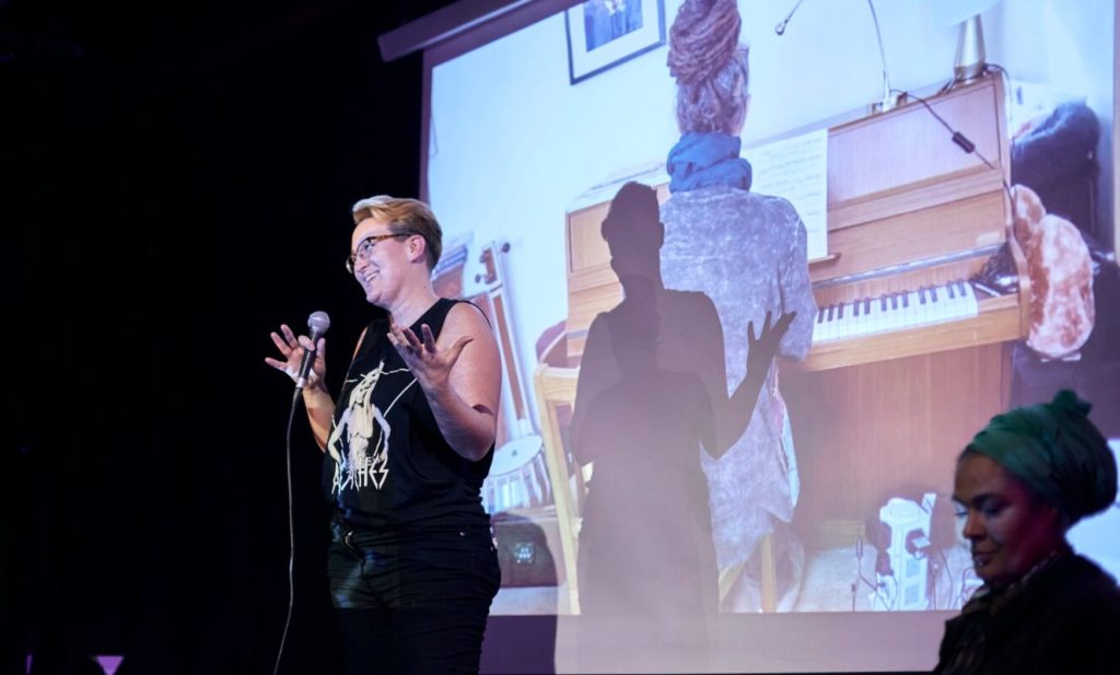 Person delivering a spoken word tribute during a celebration of life event