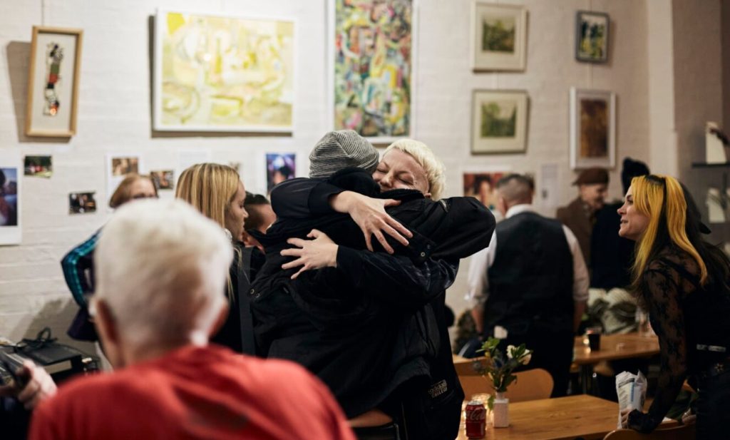 Guests hugging and offering support during a memorial celebration