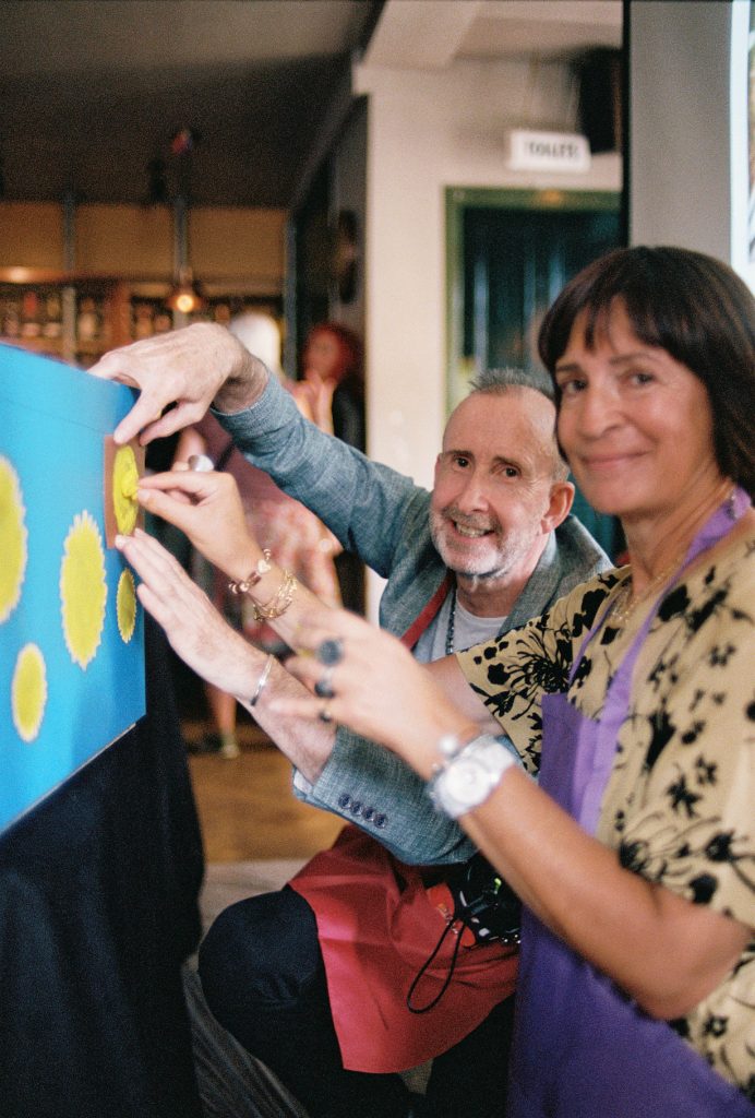 Friends decorate the coffin at a personal alternative funeral