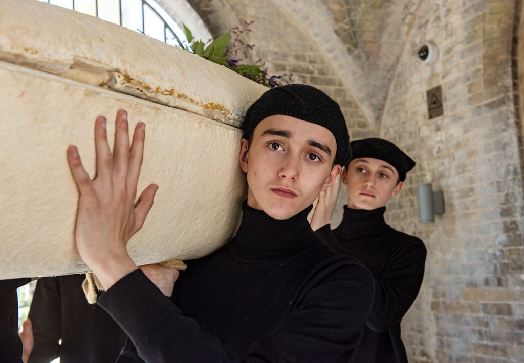 Loop Tech Mycelium Living Cocoon coffin being carried by Thereafter Funeral Services pallbearers close up