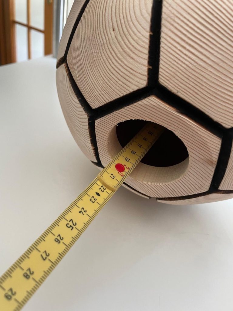 Wooden football-shaped memorial urn with base opening