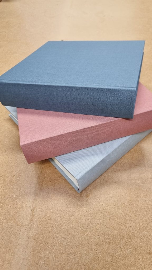 Linen Memory & Condolence books from Begolden in white, pale pink and sky blue