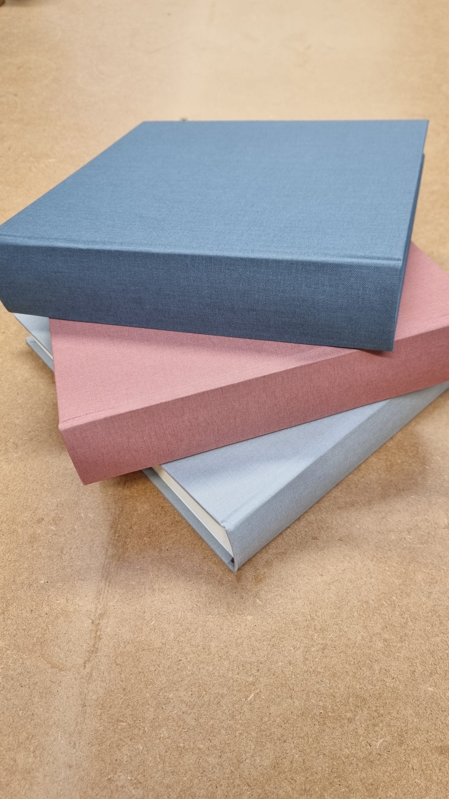 Linen Memory & Condolence books from Begolden in white, pale pink and sky blue