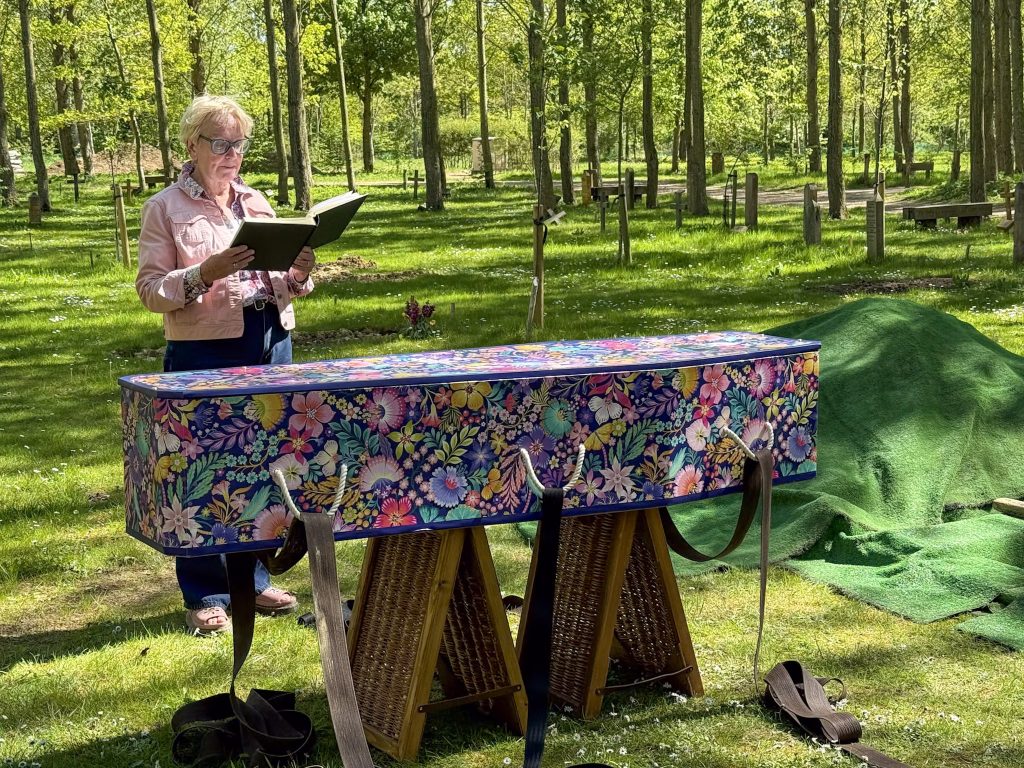 Parley Green colourful cardboard coffin by Last Dance Coffin at a natural burial