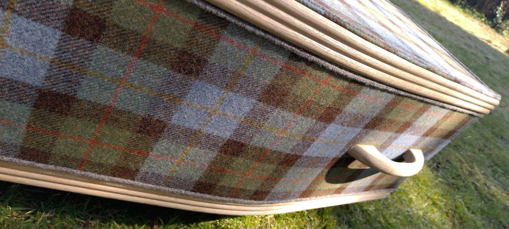 Close up of Oakley style arris Tweed® coffin with natural wood boarder