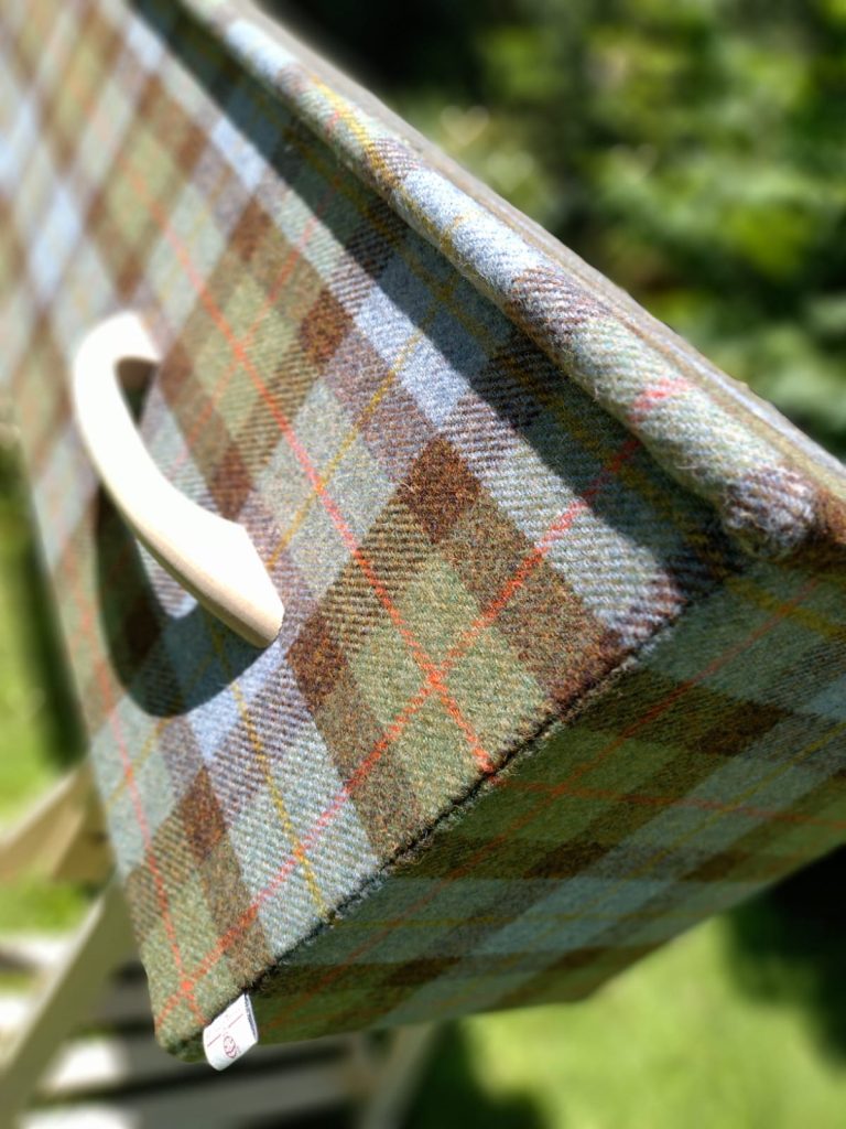 Close up of Blue and fawn Harris Tweed Coffin with wooden handle